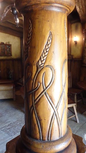 Carved wooden column in the Green Dragon Inn.