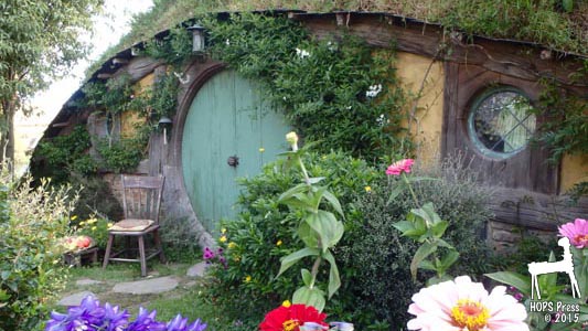 Hobbit house with green door and flowers.