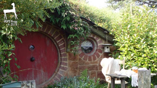 Hobbit house with brickwork framing around door and window.