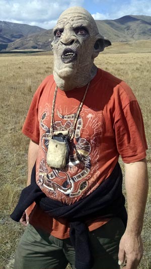 Wearing an LOTR goblin mask.