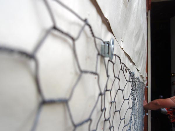 Using chicken wire for stucco work.