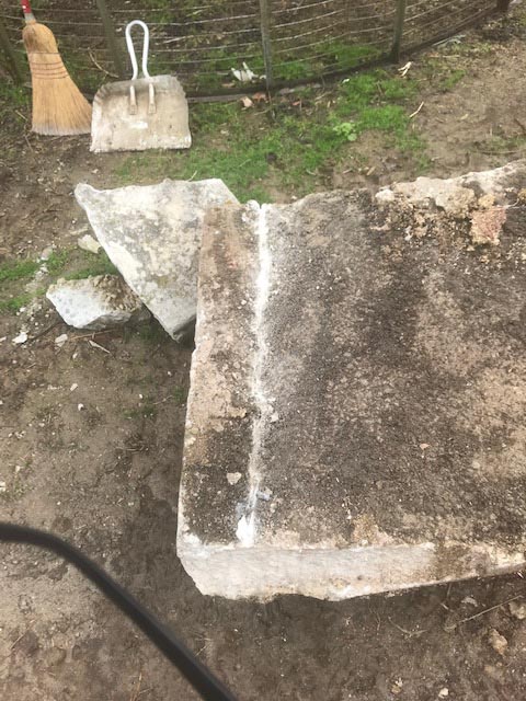 Scoring a concrete slab to split it for use as stone.