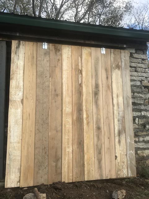 The barn features sliding doors on both sides of the building.