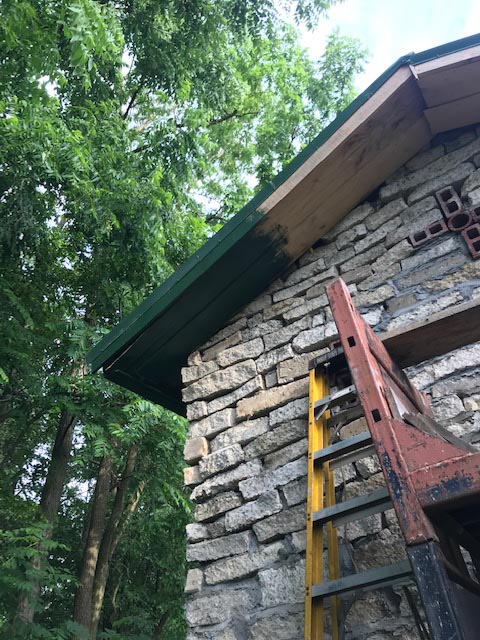 Painting the eaves of the barn.