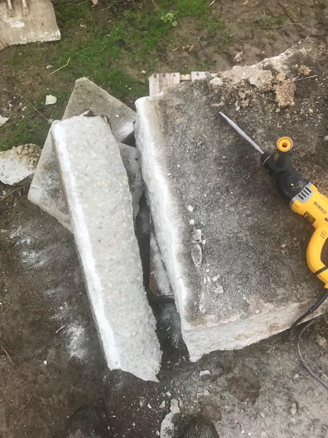 A long stone was jack-hammered from the concrete slab.