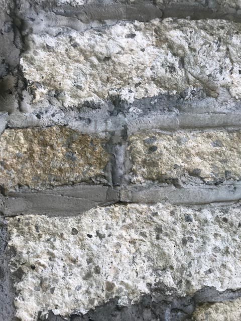 Close-up view of the grouted stonework with recycled slabs of concrete as stones.