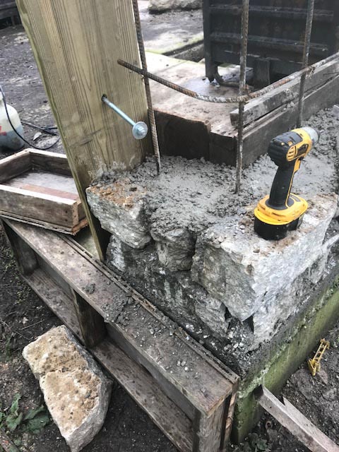Bolts will be cemented in place to connect the door frames to the stone wall.