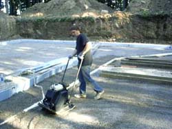 Rehl House: Compacting soil for concrete slab pour.