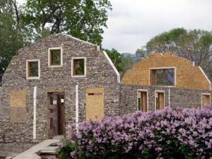 Barn shaped slipform stone house taking shape.