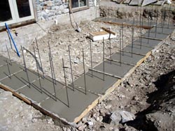Footing for greenhouse poured.