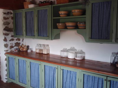 Pantry cabinets with curtain doors.