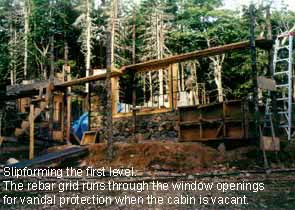 Slipform stone masonry first level with window openings.
