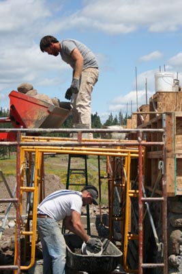 Slipform stone masonry teamwork.