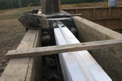 Insulation sandwiched in slipform stone wall.
