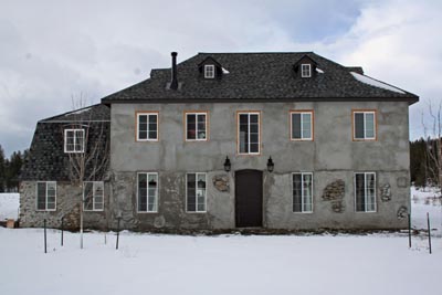 Plastering over slipform stone work.