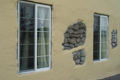 Close-up of plaster and exposed stone work.